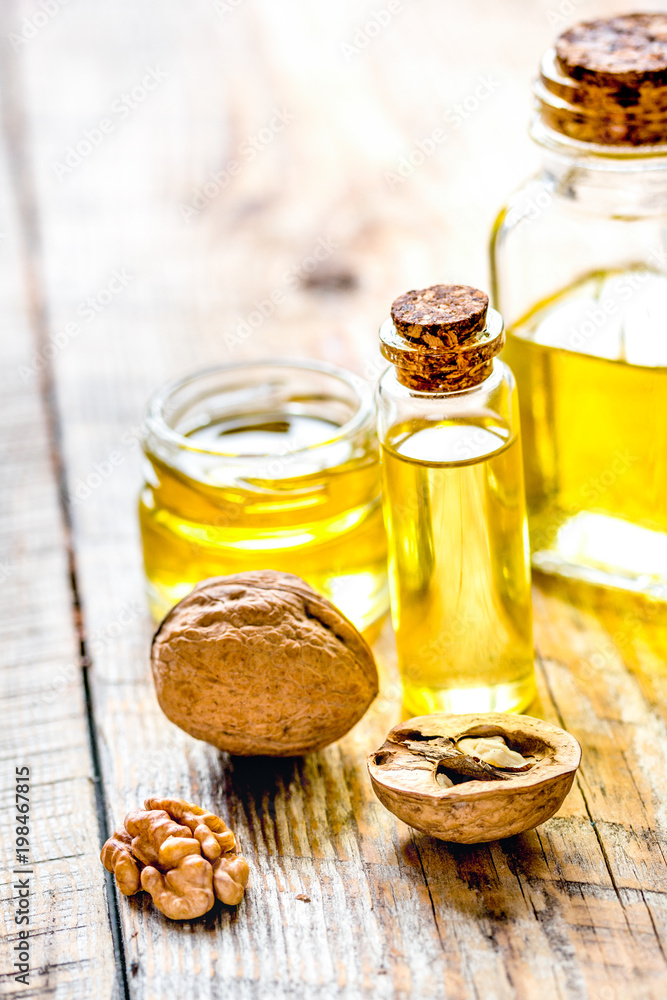 cosmetic and therapeutic walnut oil on wooden background