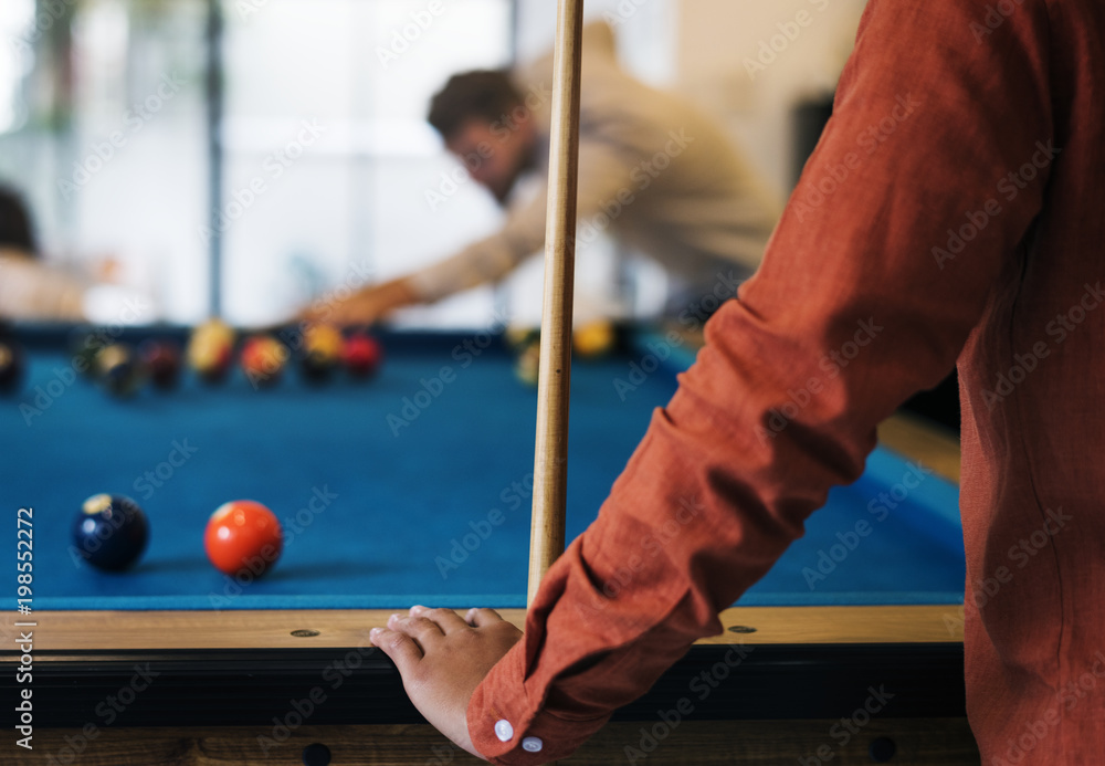 Happy friends playig pool together