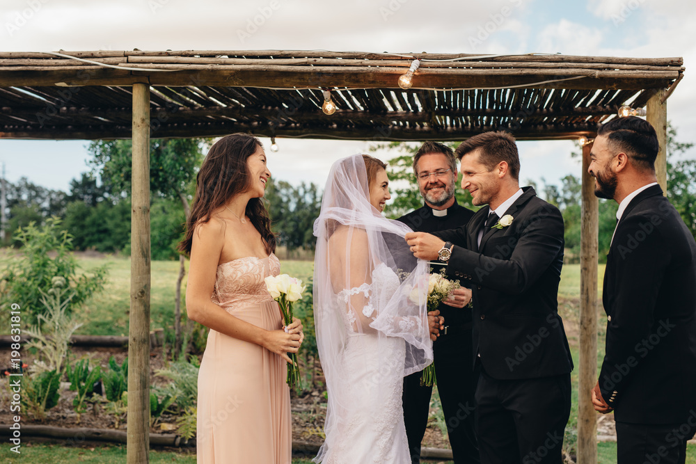 Newlywed couple about to kiss after the ceremony