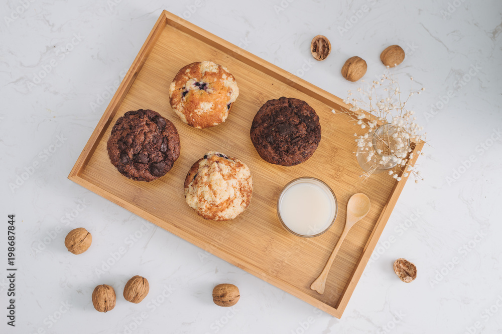 Breakfast with fresh homemade delicious muffins and milk.