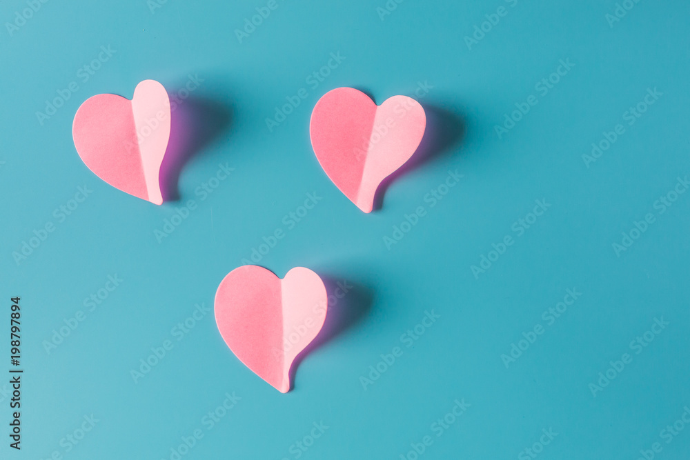 Pink paper hearts isolated on blue background, Symbol of love on sweet blue background, greeting car