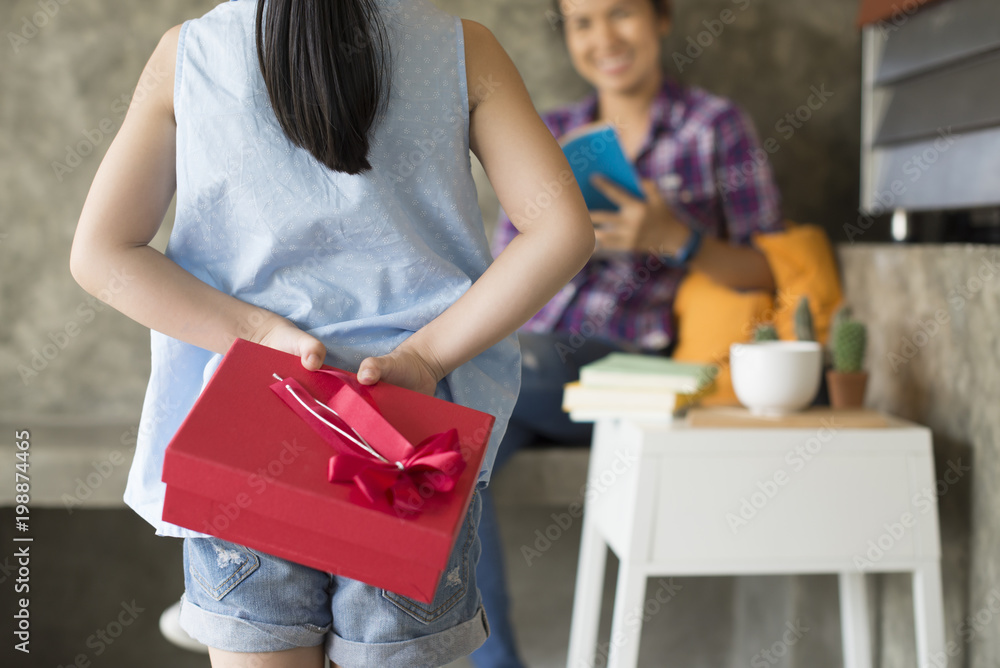 Little girl is giving her mom a present