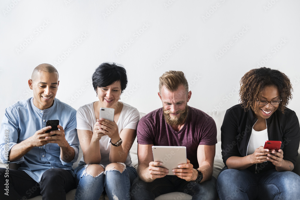 Group of diverse people using digital devices