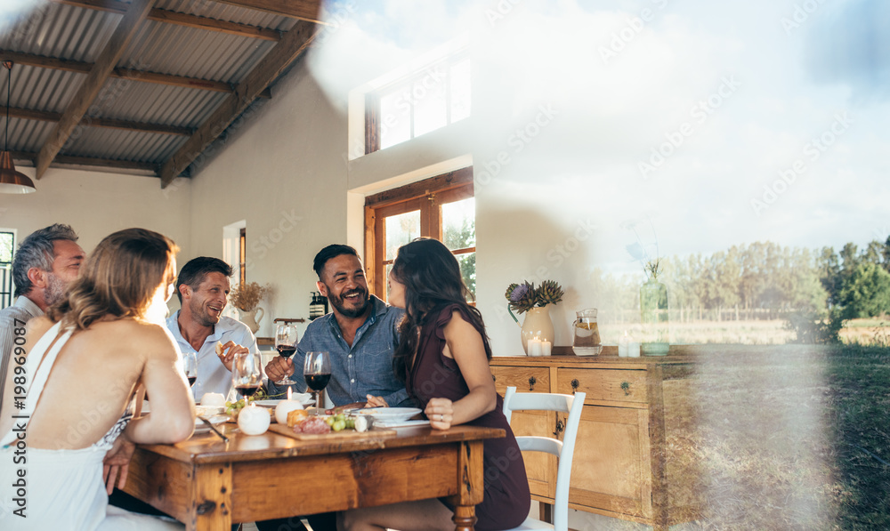 Friends enjoying meal at home together