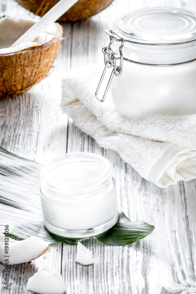 organic cosmetics with coconut on wooden background close up