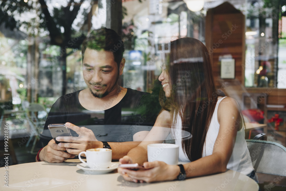 Lovely asian couple having coffee