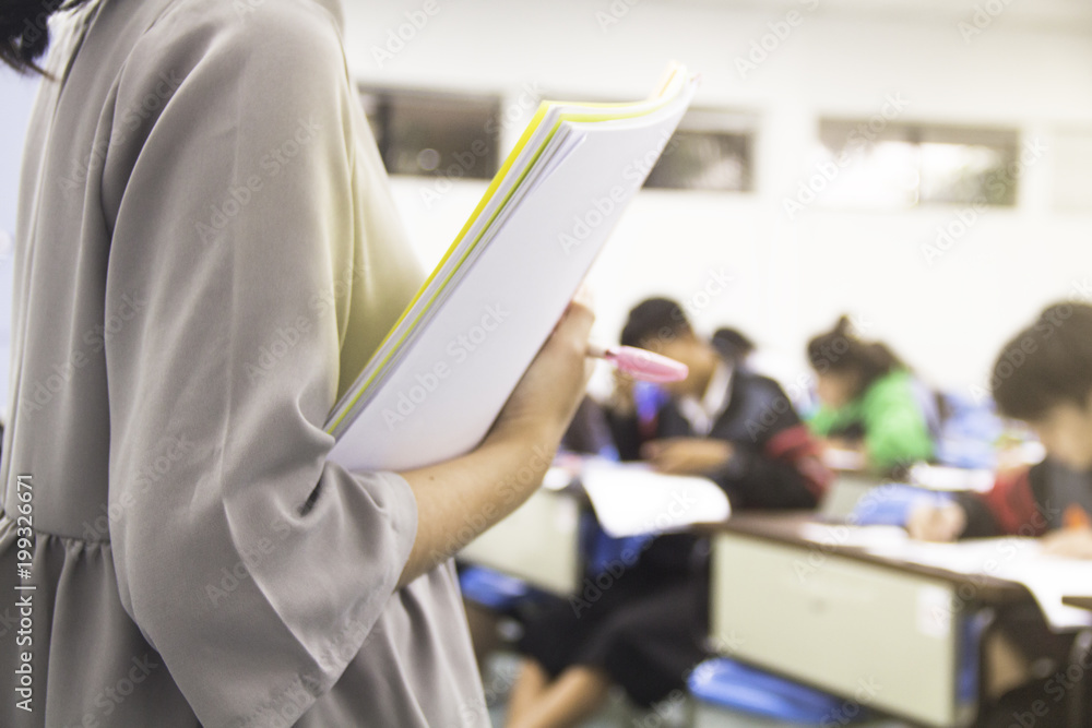 Teacher teach students and background of students during study or quiz, test and exams in large lect