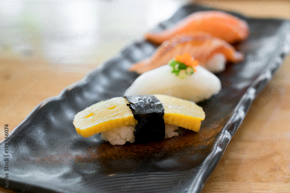 Close up of japanese cuisines nigiri sushi set on black plate served in japanese food restaurant.