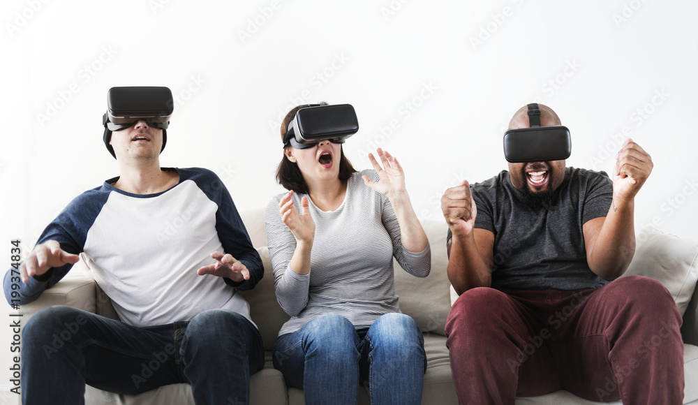 Group of diverse friends enjoying virtual reality experience