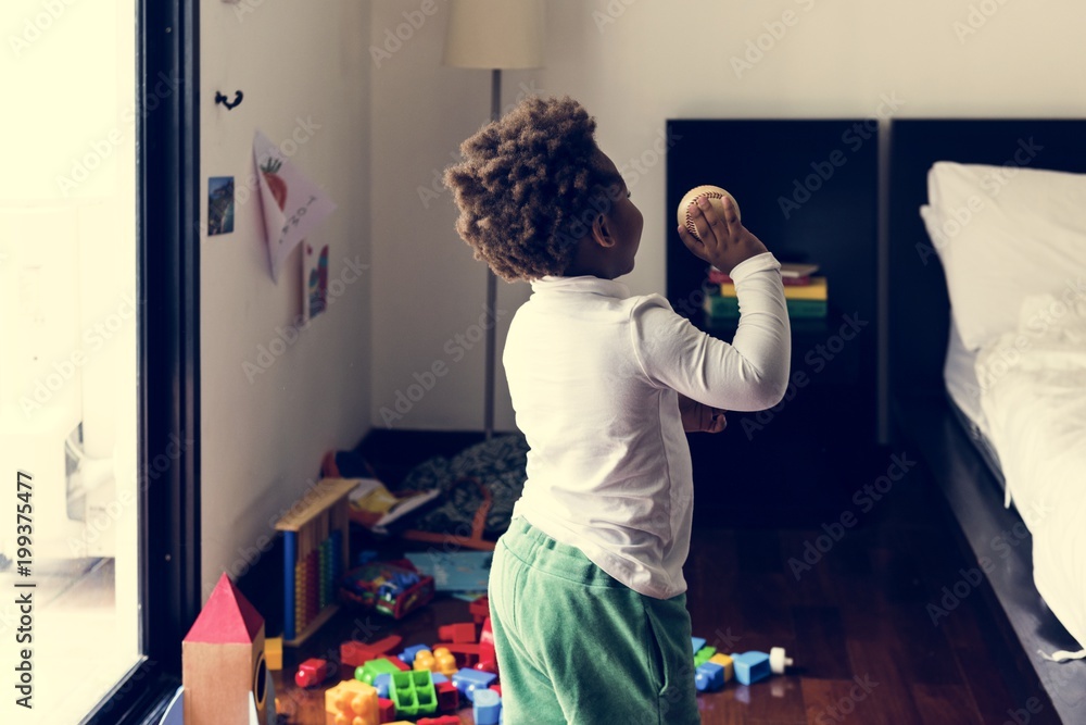 Black kid throwing baseball ball