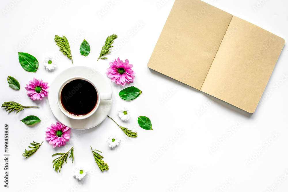 Froral flat lay with cup and notepaper top view mockup