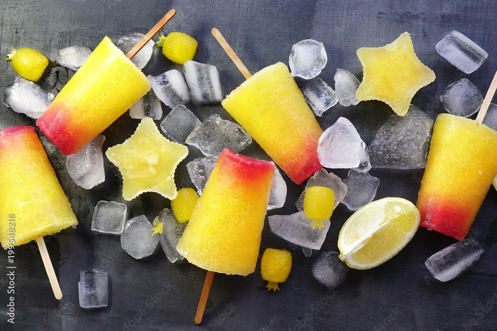 Sweet refreshing summer food concept. Summer ice cream fruit ice stars yellow orange and red colors 