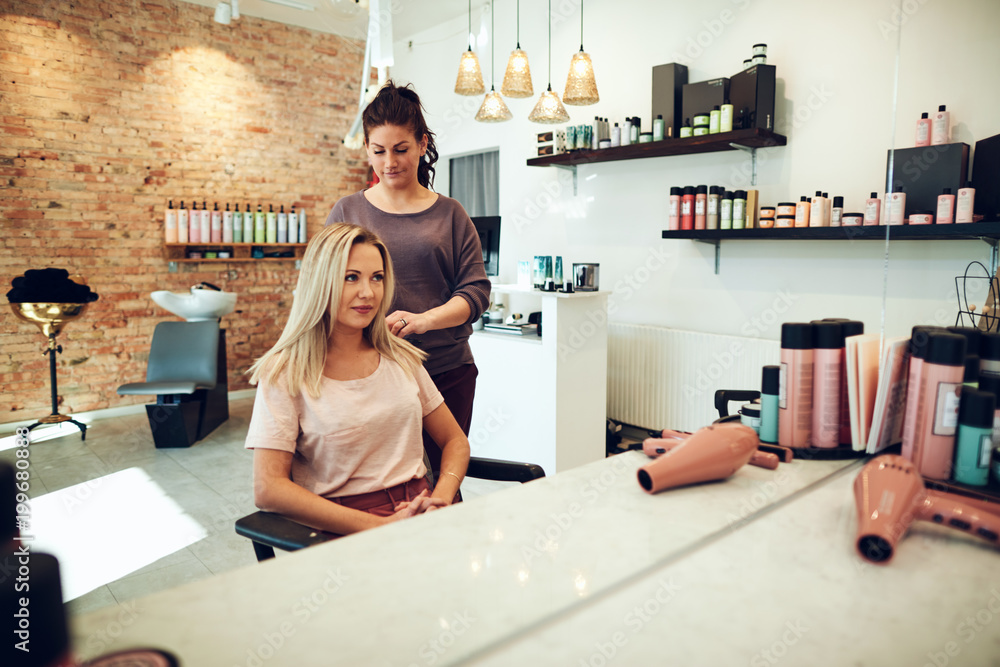 Smiling woman talking with her hairstylist in a salon