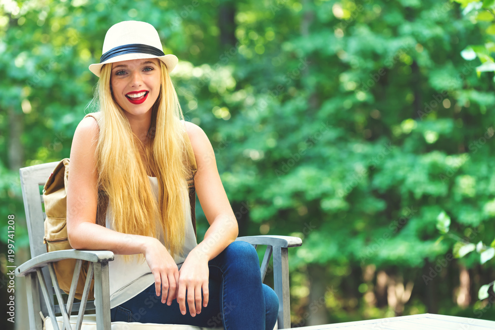 Young woman sitting outside on a beautiful summer day