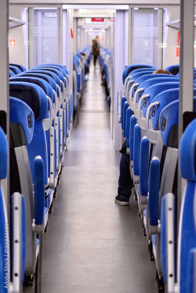 Modern railway coach interior illuminated and row of seats