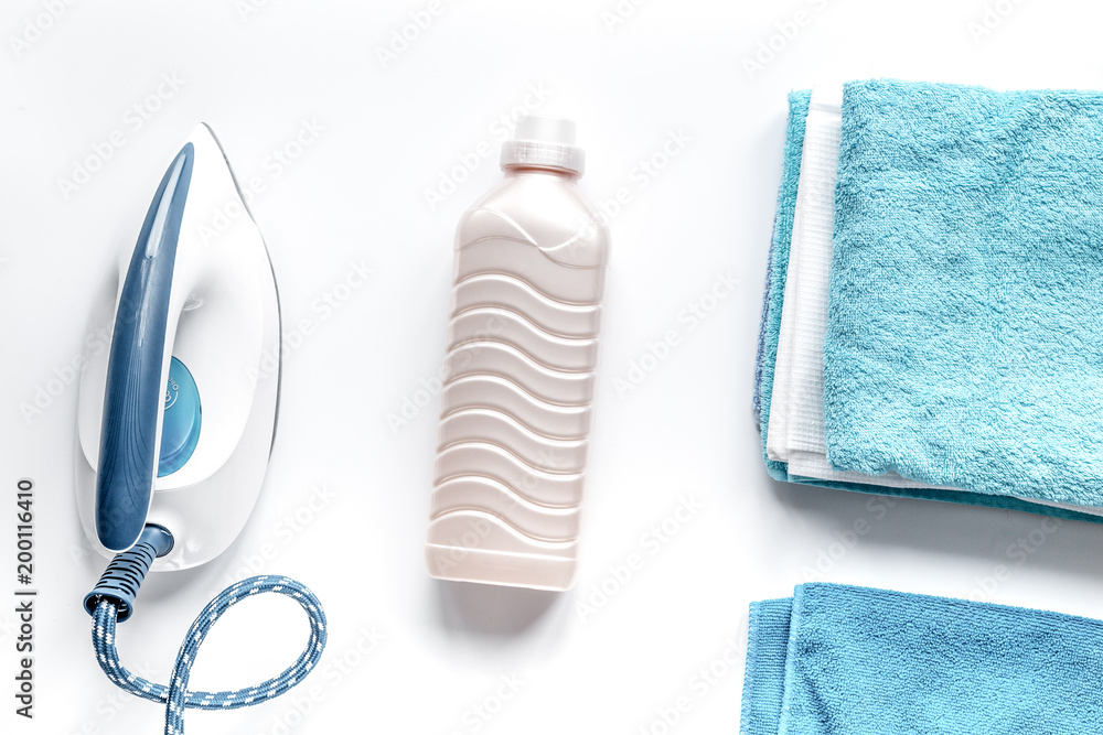 housekeeping set with towels and iron on laundry background top 