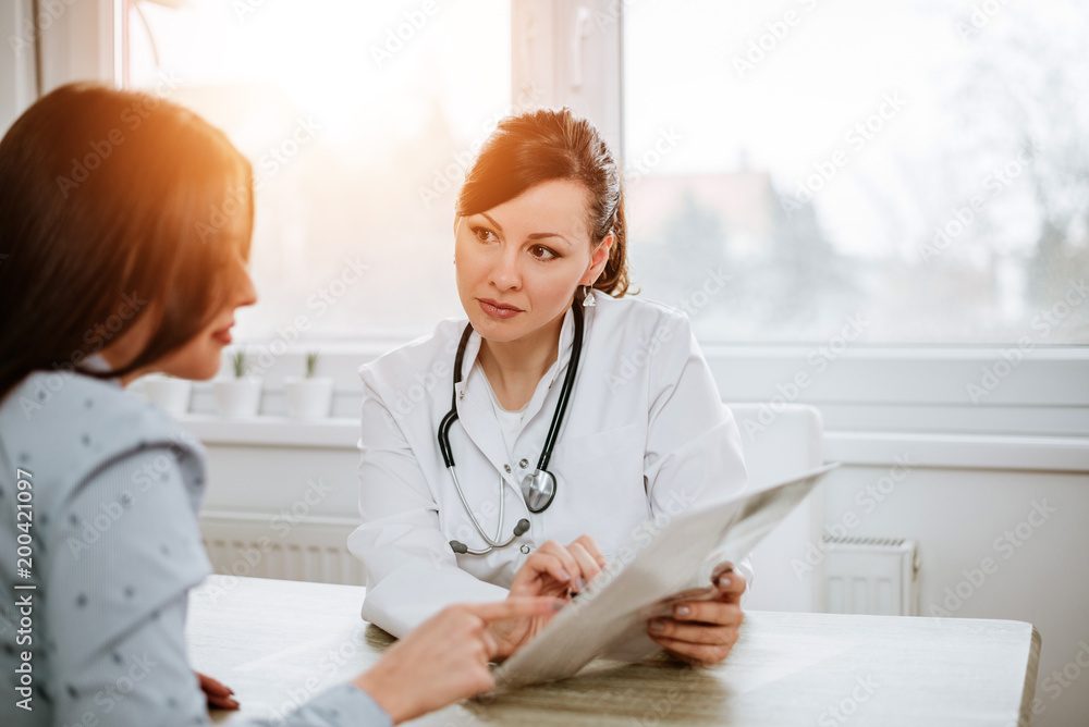 Healthcare and medicine concept. Beautiful female doctor explaining results to her patient.