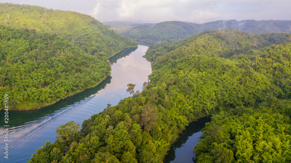 Forest and river on the mist, Top view tropical rainforest in Thailand.