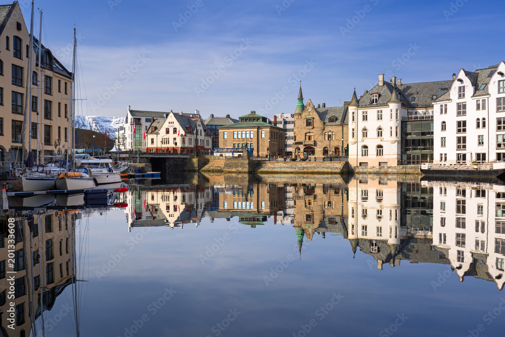 Architecture of Alesund town reflected in the water, Norway