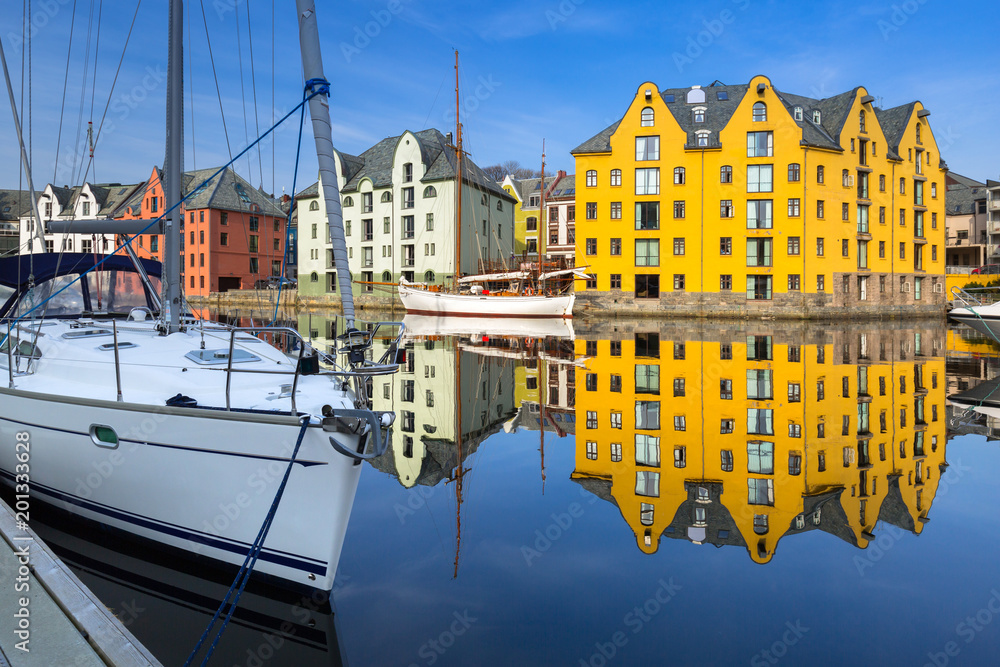 Architecture of Alesund town reflected in the water, Norway