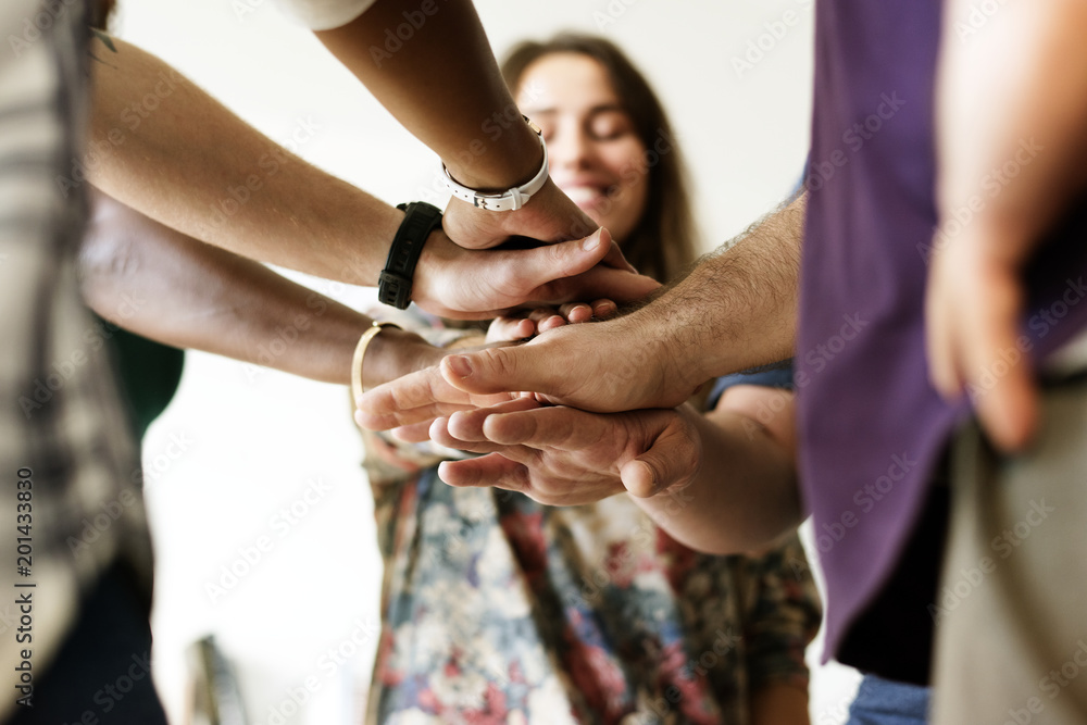 Group of diverse people joined hands together teamwork