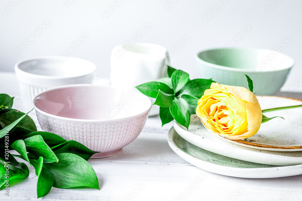 ceramic tableware with flowers on white background