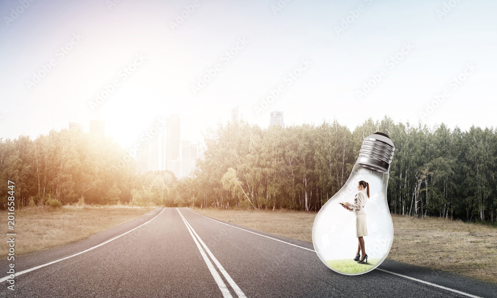 Businesswoman inside light bulb