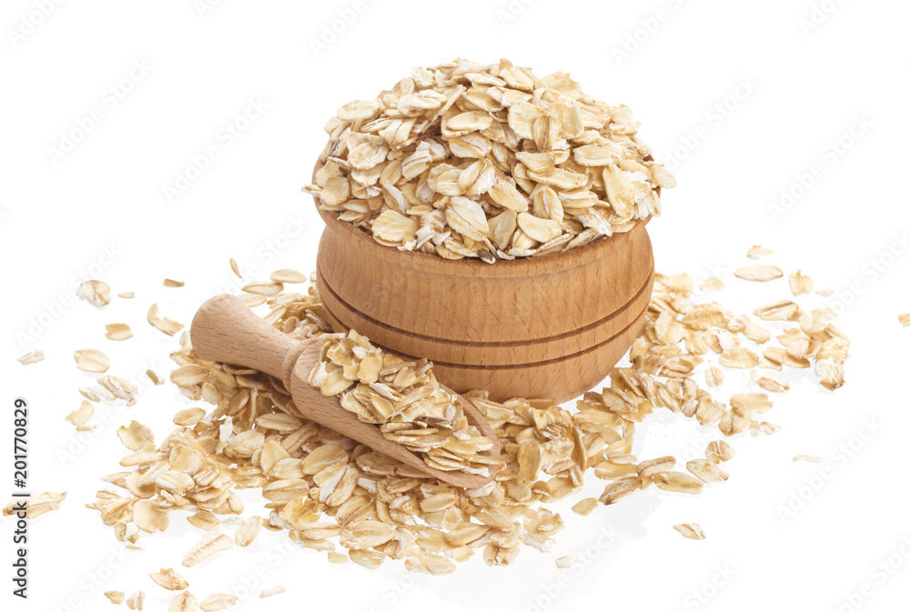 Oat flakes in wooden bowl isolated on white background