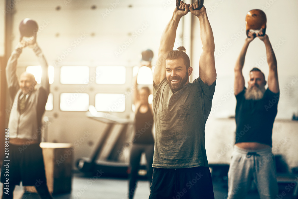 People working out during a weight session at the gym