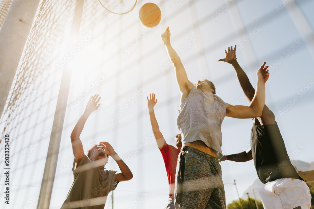 Men playing basketball