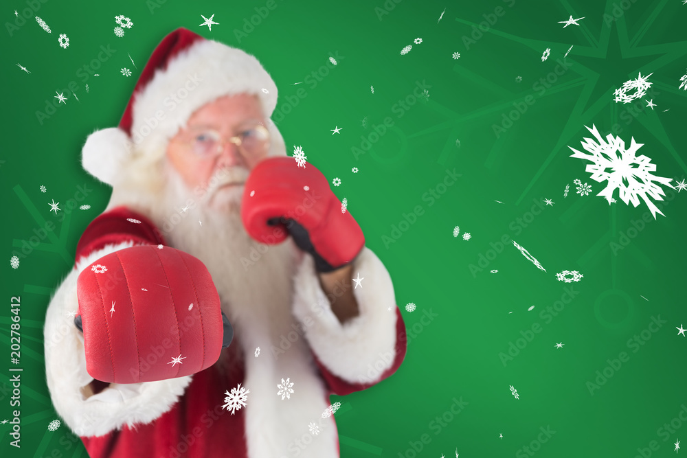 Santa Claus punches with his right against green snowflake background