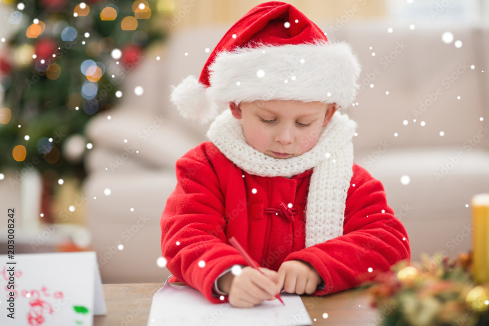 Festive little boy writing wish list against snow