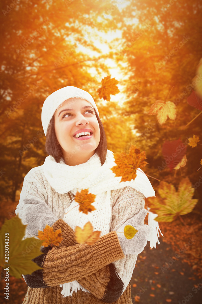 Brunette in warm clothing against autumn scene