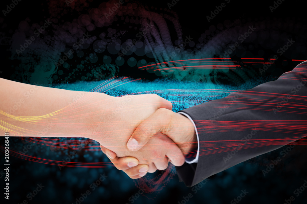 Close up of a handshake against abstract glowing black background