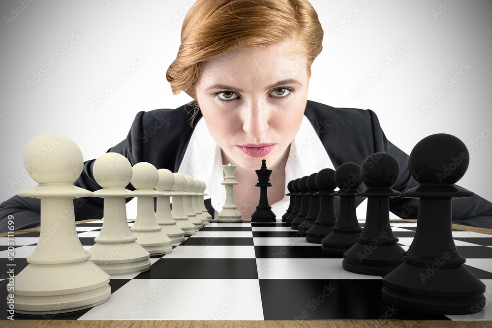 Composite image of focused businesswoman with chessboard