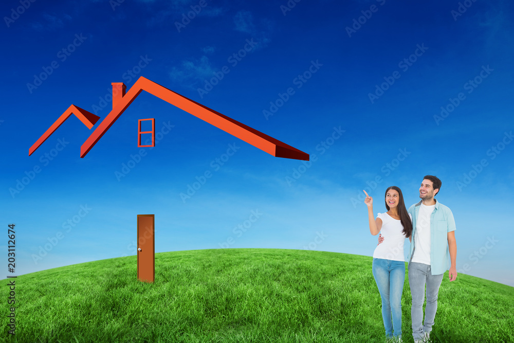 Happy casual couple walking together against green hill under blue sky