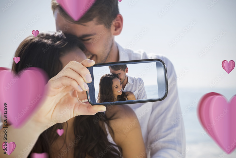 Composite image of valentines couple taking a selfie