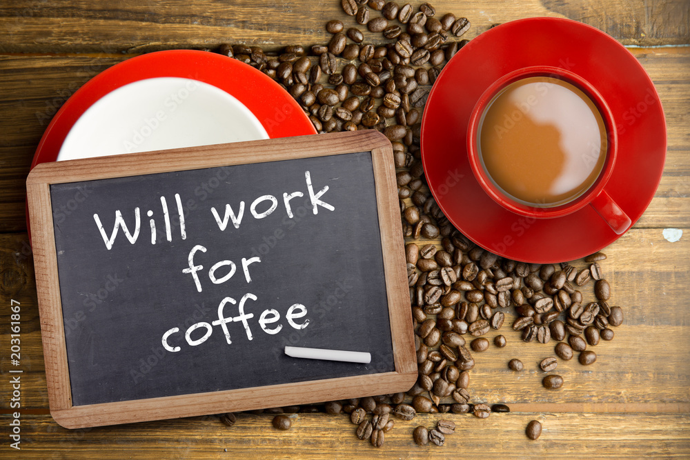 Red cup of coffee against chalkboard with piece of chalk