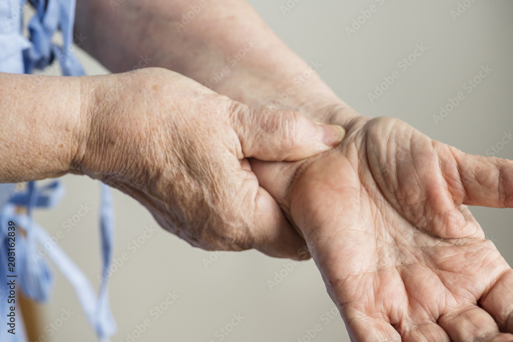 Closeup of elderly hands checking pulse