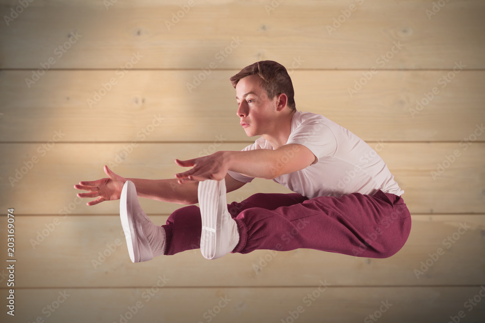 Cool break dancer against bleached wooden planks background