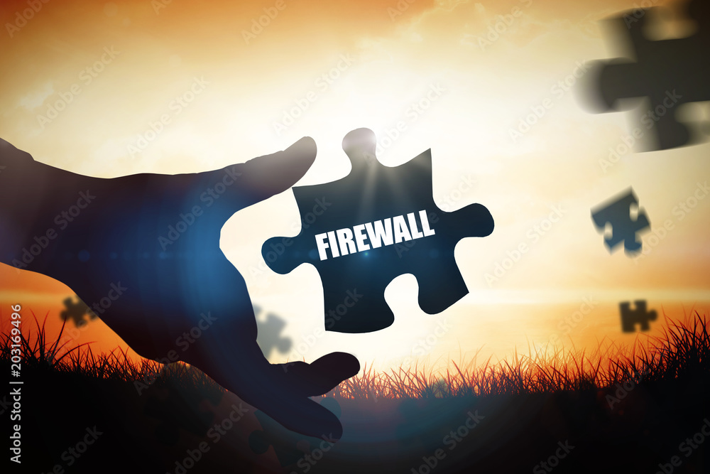 The word firewall and businessman pointing with his finger against orange sunrise