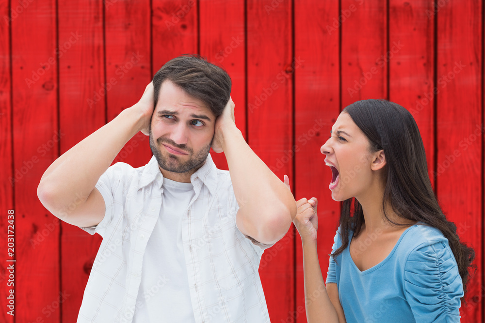 Angry brunette shouting at boyfriend against red wooden planks