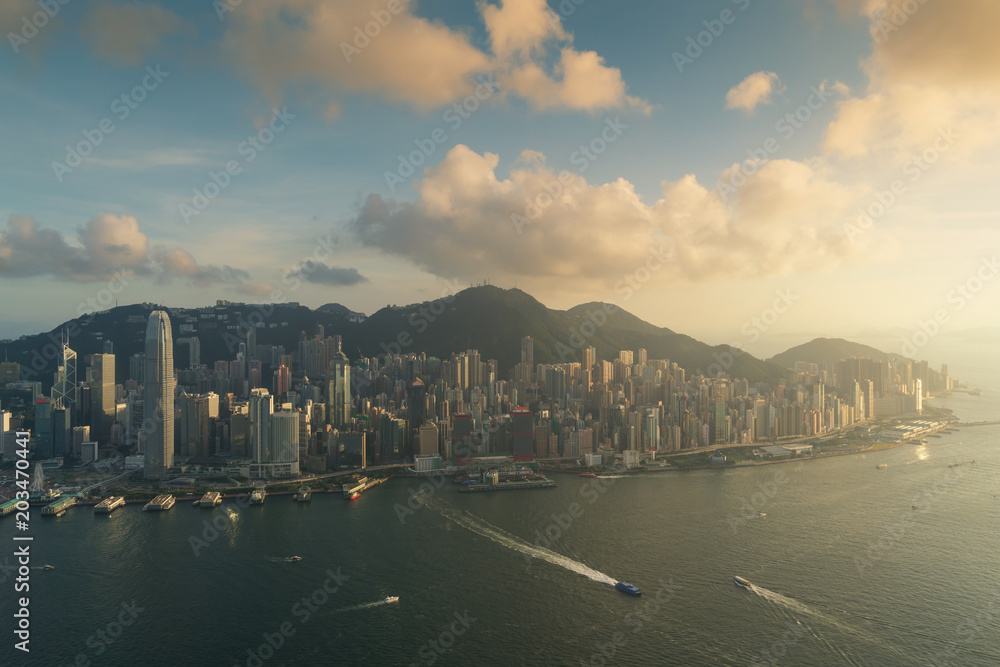 Aerial view of Hong Kong skyline and Victoria Harbor during sunset in Hong Kong. Asia..