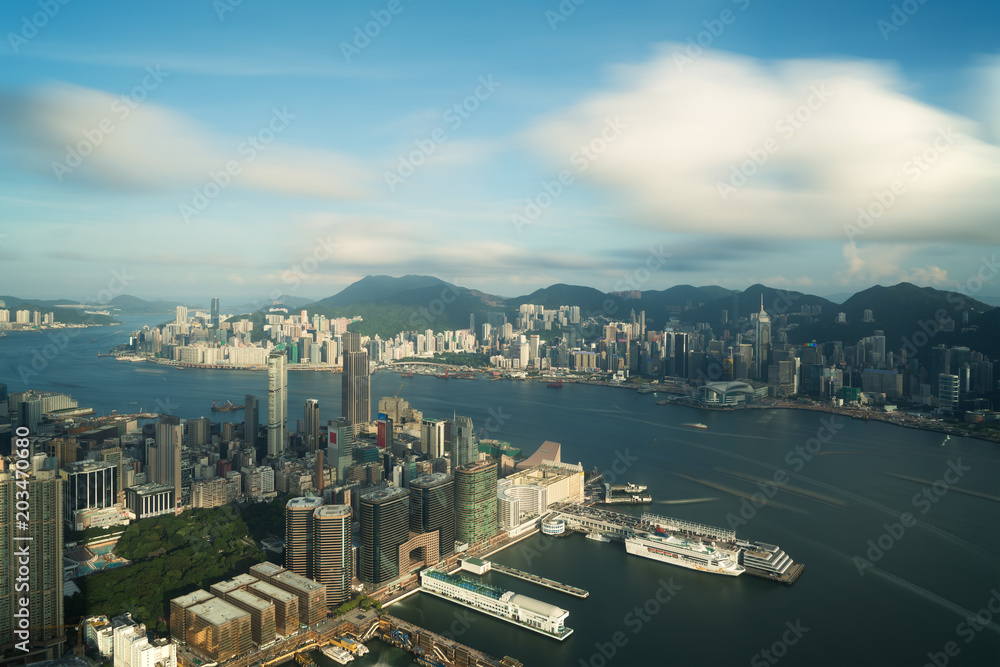 Aerial view of Hong Kong skyline and Victoria Harbor with blue sky in Hong Kong. Asia..