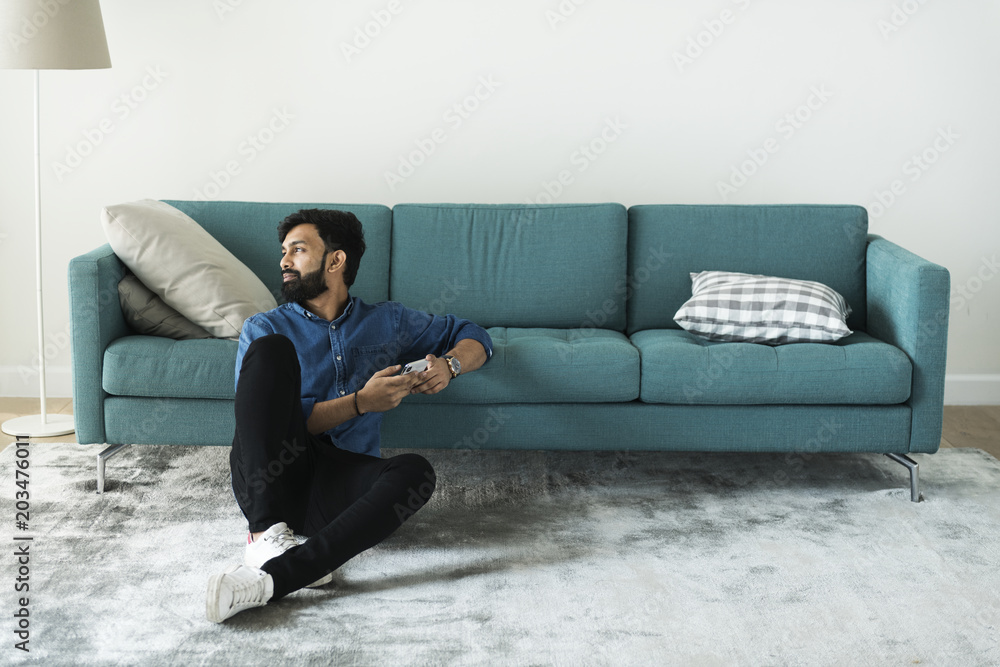 Man using mobile phone on the floor alone