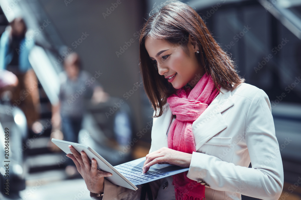 Asian business woman use a laptop she is working at the subway.