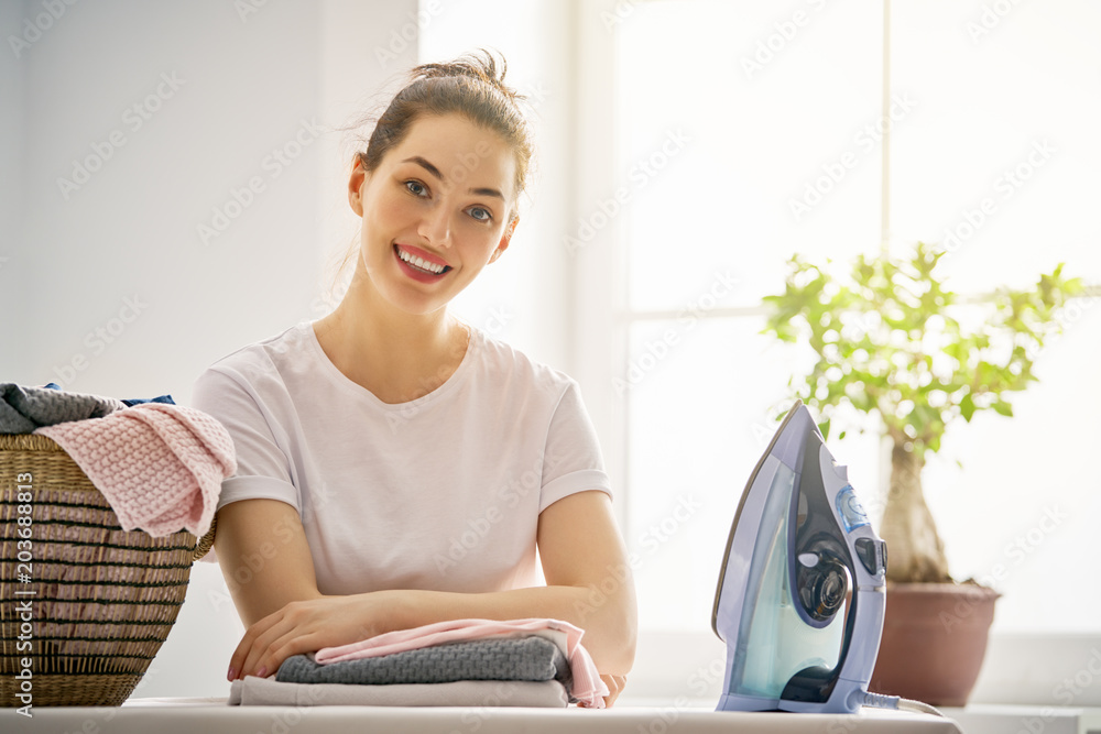 woman is ironing at home