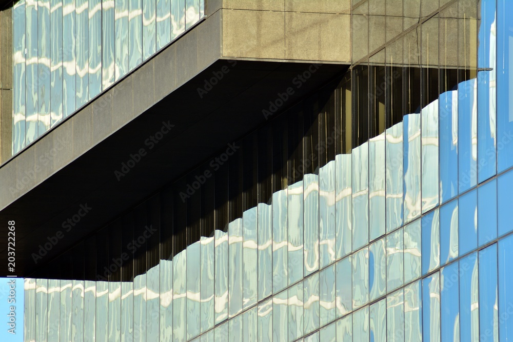 Urban abstract background, detail of modern glass facade, office business building.