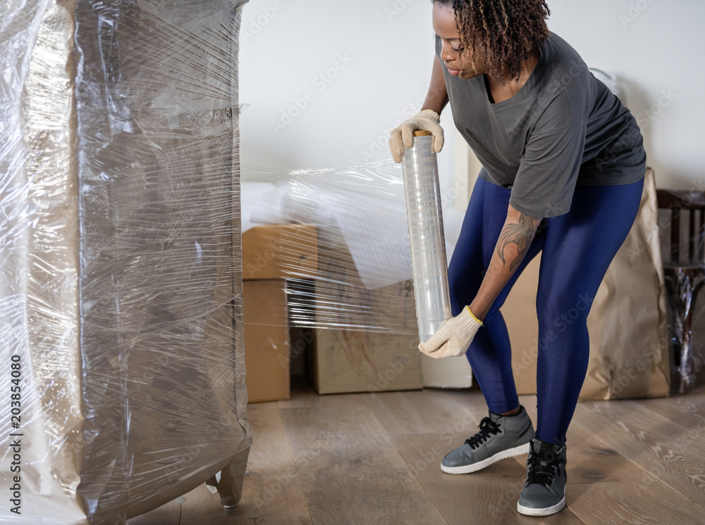 Black woman moving furniture