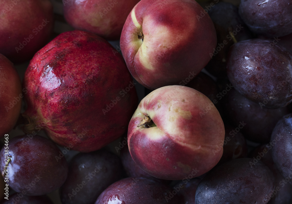 Closeup of plums and other fruits